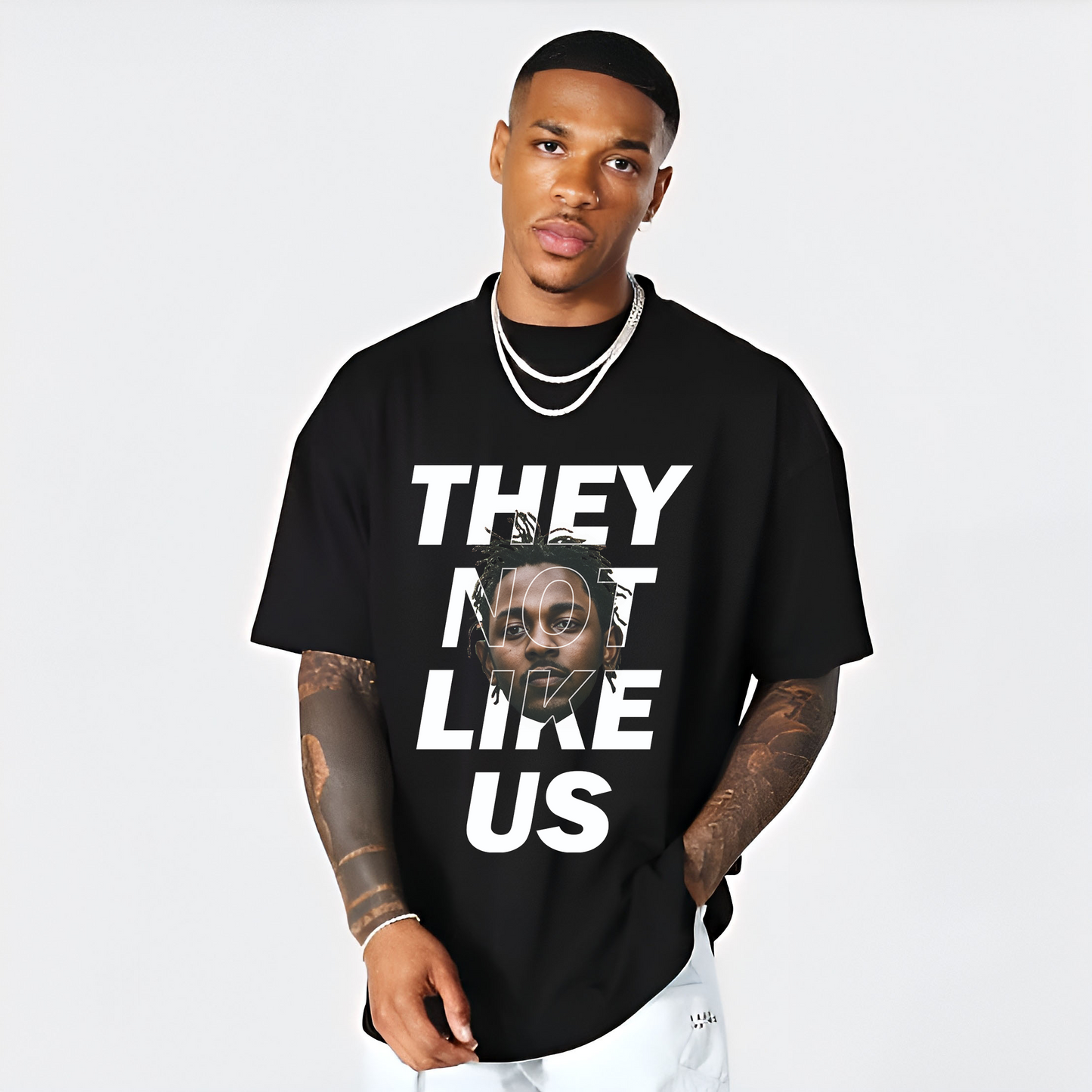 “They Not Like Us” bold typography graphic t-shirt design with a portrait overlay, from Urban Drip streetwear collection.
